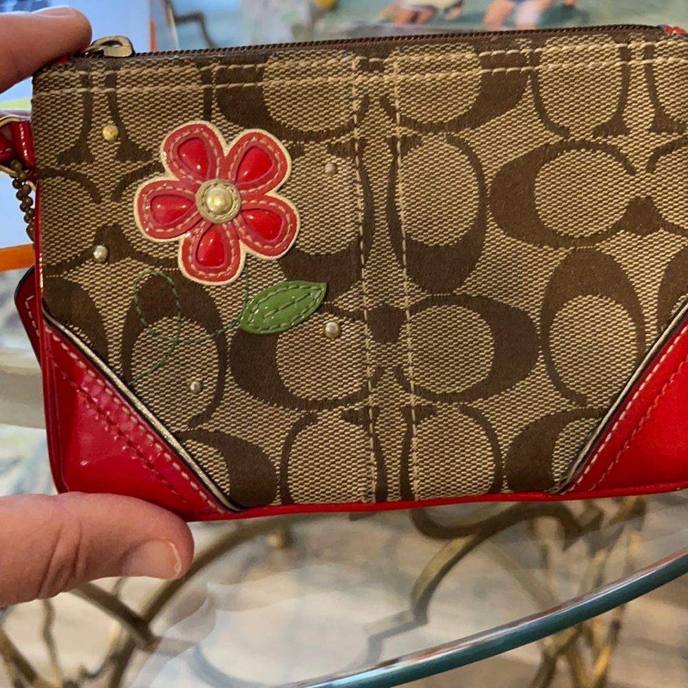 Coach wristlet with flower appliqué